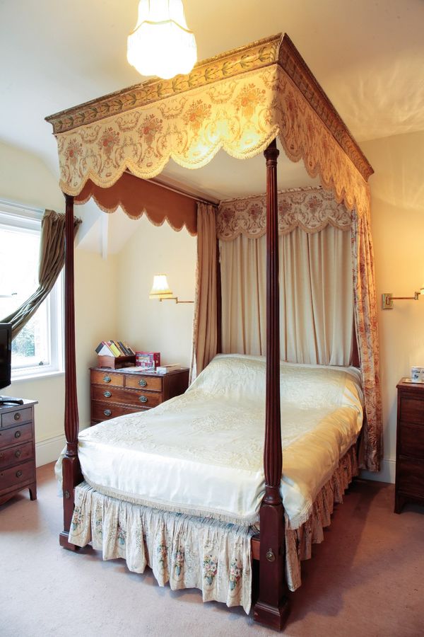 A GEORGE III MAHOGANY FOUR-POSTER BED
