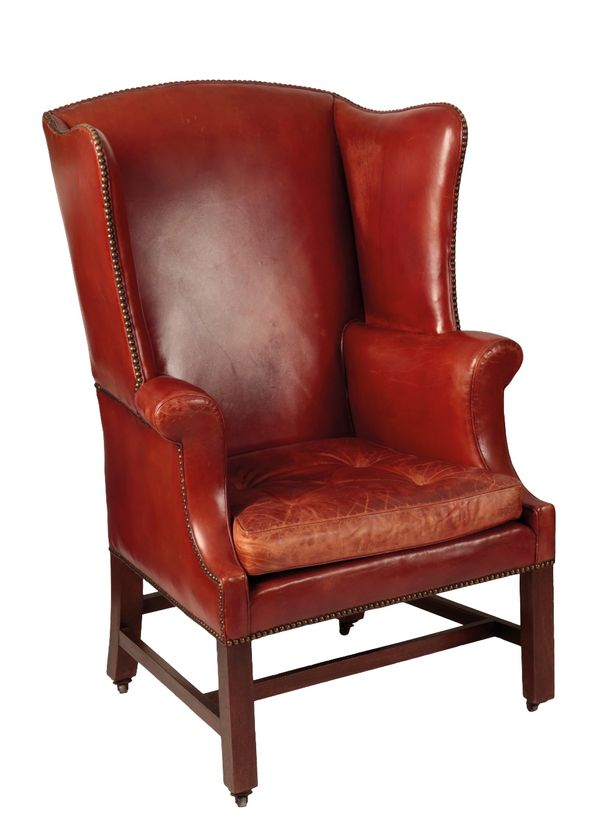 GEORGE III MAHOGANY AND LEATHER UPHOLSTERED WING ARMCHAIR