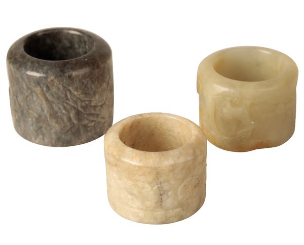 THREE CARVED JADE ARCHERS RINGS