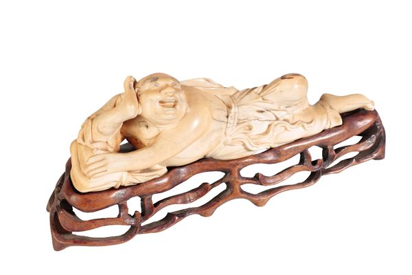 CARVED IVORY FIGURE OF A RECLINING BUDDHA