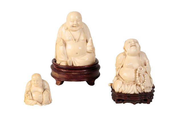 THREE CARVED IVORY FIGURES OF LAUGHING BUDDHAS