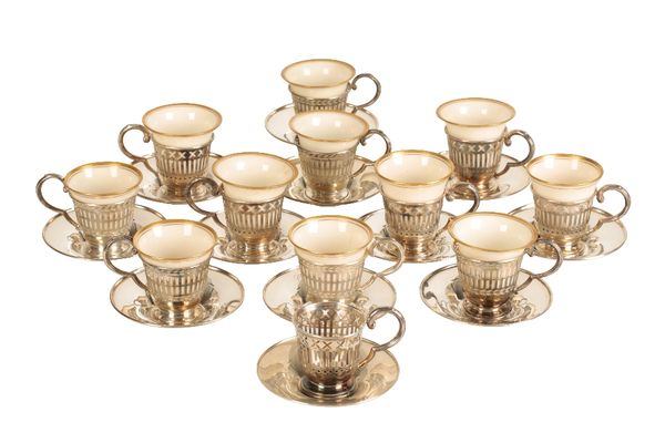 TWELVE EDWARDIAN SILVER CASED DEMITASSE CANS AND SAUCERS