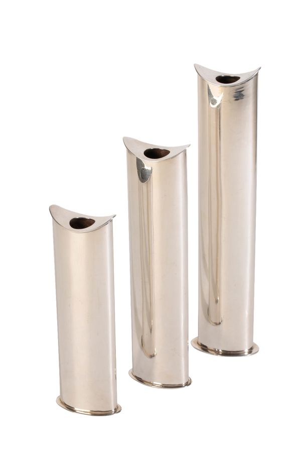 IN THE MANNER OF GEORG JENSEN: A SET OF THREE GRADUATED SILVER CANDLESTICKS