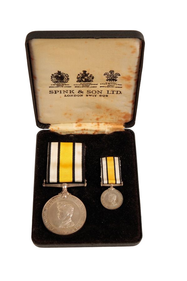 A CASED SPINKS BRUNEI GURKHA RESERVE MEDAL AND MINIATURE