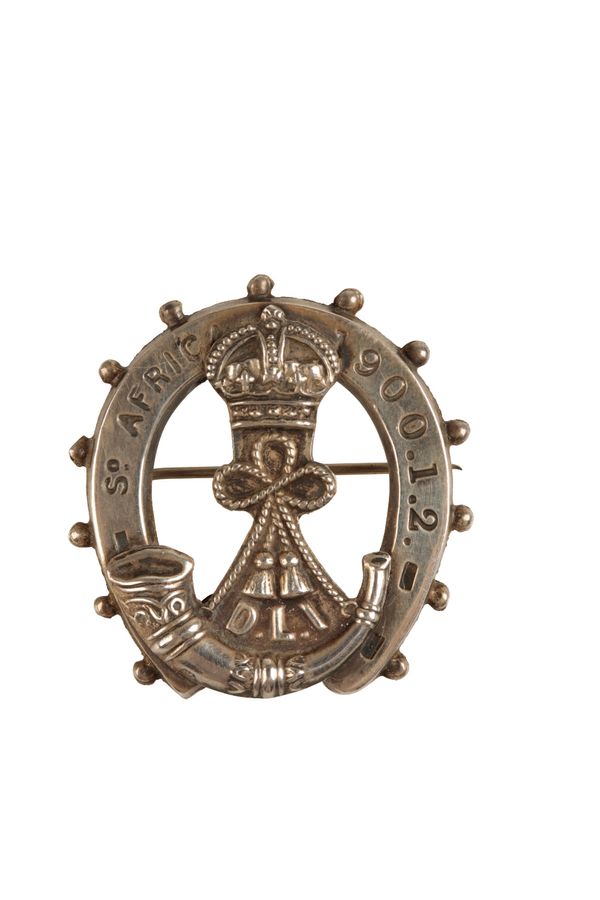 A SILVER BADGE COMMEMORATING THE DLI IN SOUTH AFRICA 1900 -1902