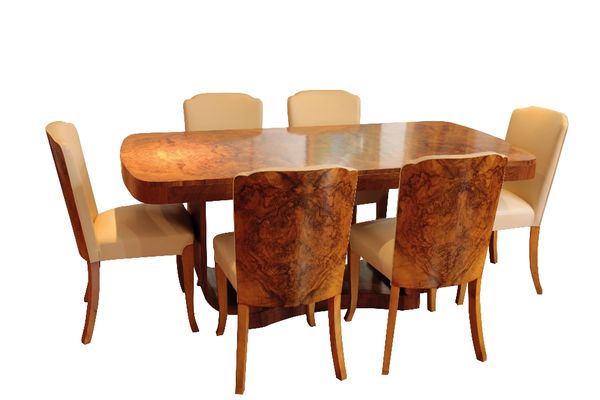 HARRY AND LOU EPSTEIN: AN ART DECO FIGURED WALNUT "CLOUD" DINING TABLE AND CHAIRS
