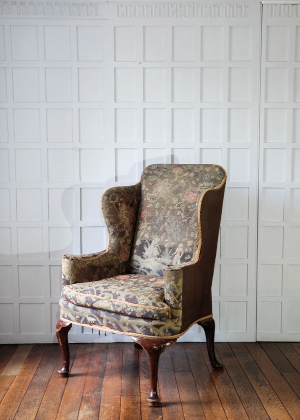 A GEORGE I STYLE WALNUT WING ARMCHAIR