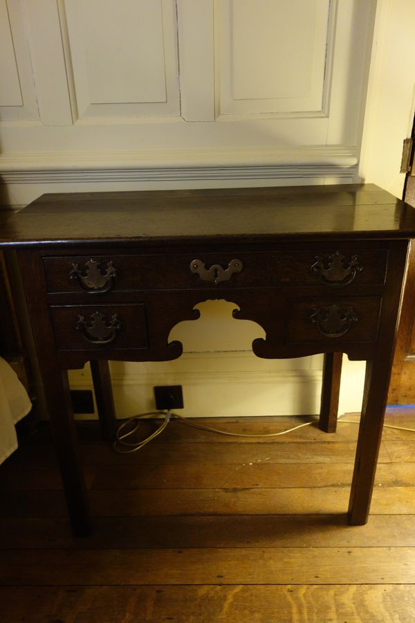 A GEORGE III OAK LOWBOY