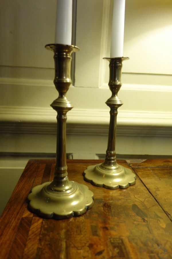 A PAIR OF GEORGE II BRASS CANDLESTICKS