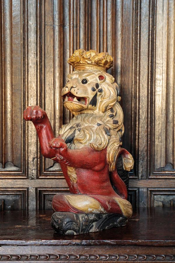 A CARVED GILTWOOD AND POLYCHROME HERALDIC LION