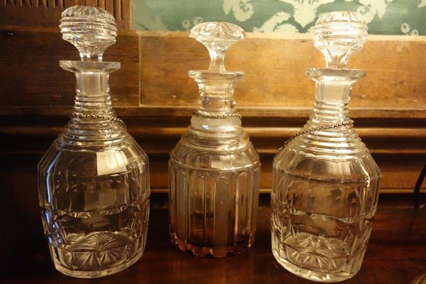 A PAIR OF LATE REGENCY CUT-GLASS DECANTERS AND STOPPERS