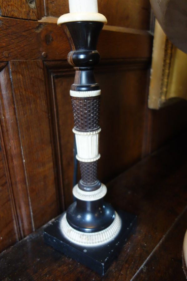 A PAIR OF ANGLO-INDIAN EBONY AND IVORY CANDLESTICKS