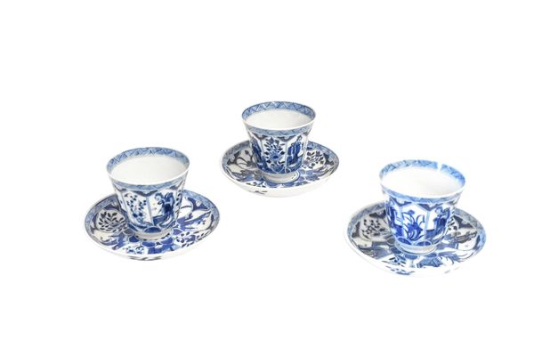 THREE BLUE AND WHITE TEACUPS AND SAUCERS, KANGXI PERIOD