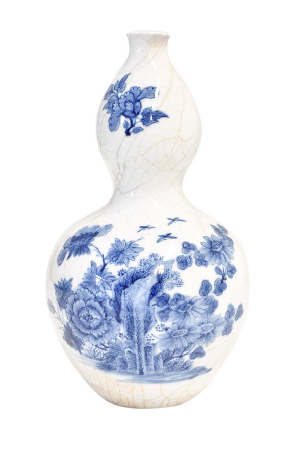 BLUE AND WHITE SOFT PASTE CRACKLE-GLAZE DOUBLE GOURD VASE, QING DYNASTY, 19TH CENTURY