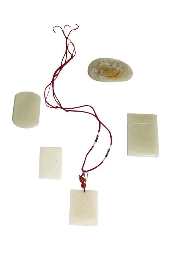 FOUR CARVED JADE PENDANTS