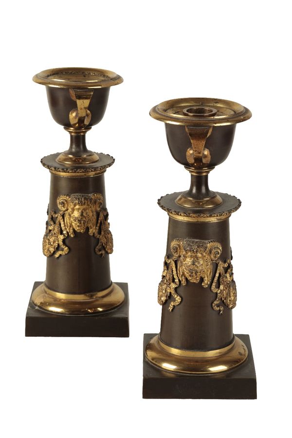 PAIR OF REGENCY PATINATED AND PARCEL GILT BRONZE CANDLESTICKS