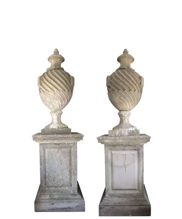 PAIR OF SUBSTANTIAL AND IMPOSING STONE COMPOSITION GARDEN URNS ON PLINTHS