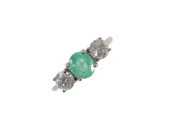 AN EMERALD AND DIAMOND THREE STONE RING