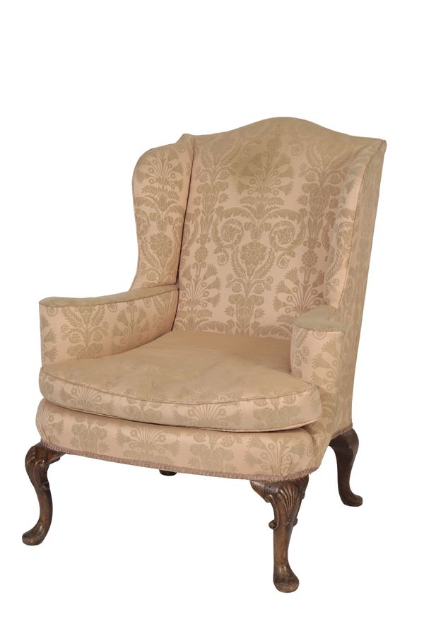 CARVED AND STAINED WOOD AND UPHOLSTERED WING ARMCHAIR