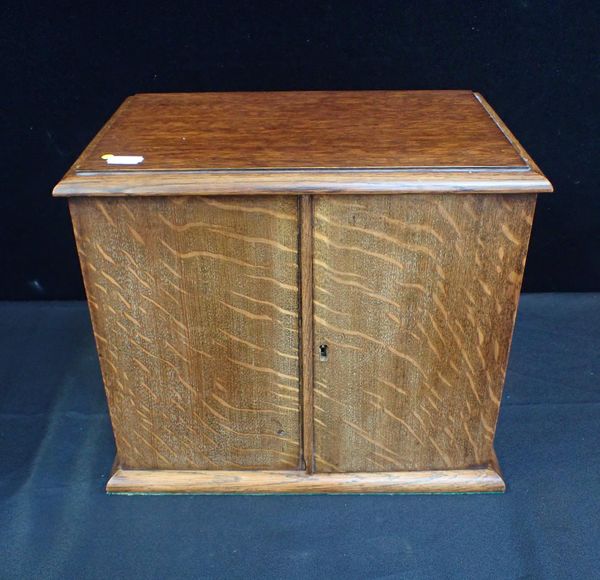 AN EDWARDIAN OAK SMOKERS' CABINET