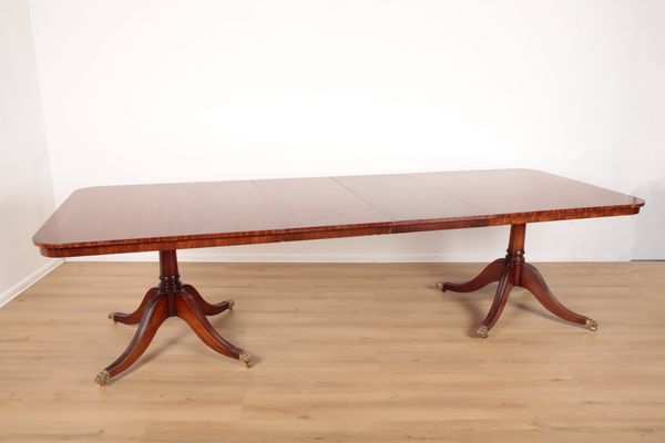 A MAHOGANY TWIN PEDESTAL DINING TABLE IN GEORGE III STYLE