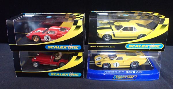 FOUR BOXED SCALEXTRIC CARS