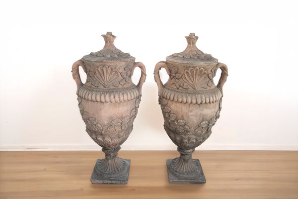A PAIR OF TERRACOTTA COLOURED GARDEN URNS