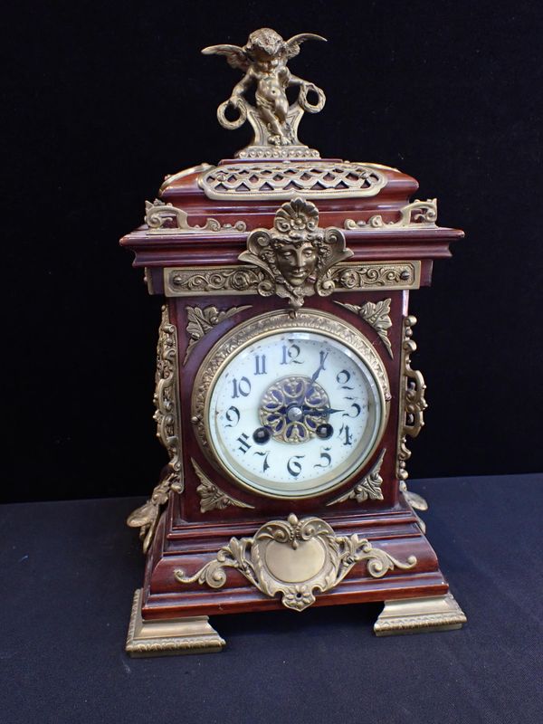 AN EARLY 20th CENTURY MAHOGANY AND BRASS CASED CLOCK