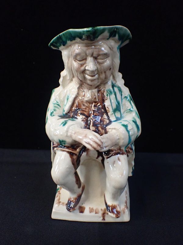 AN 18TH CENTURY CREAMWARE TOBY JUG