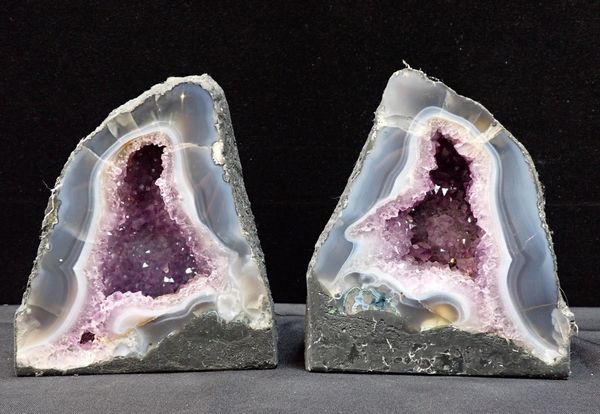 A PAIR OF AMETHYST 'CATHEDRAL' GEODE SECTIONS