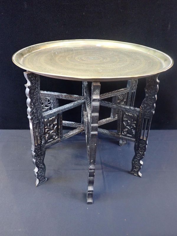 AN EGYPTIAN BRASS TRAY-TOPPED TABLE