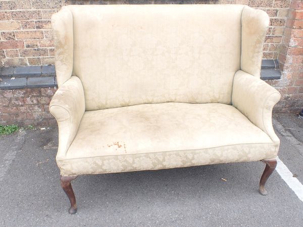 A GEORGE I STYLE WING-BACK SETTEE