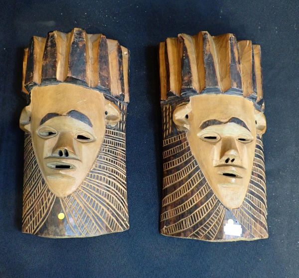 A PAIR OF AFRICAN CARVED WOODEN FACE MASKS