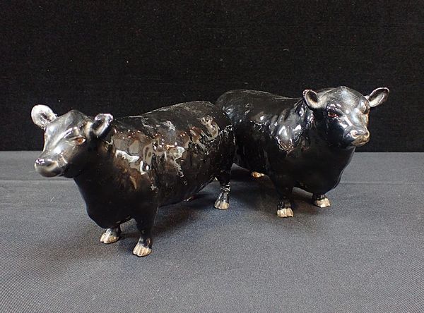 A BESWICK BLACK BULL AND COW