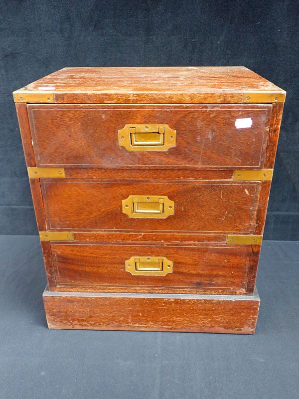 A BRASS BOUND CAMPAIGN STYLE MINIATURE CHEST OF DRAWERS