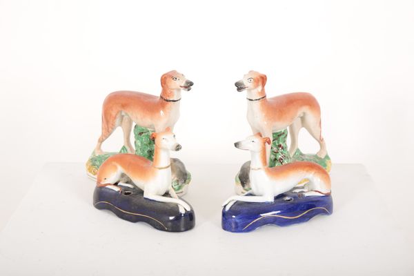 A PAIR OF STAFFORDSHIRE POTTERY GREYHOUND INKWELLS