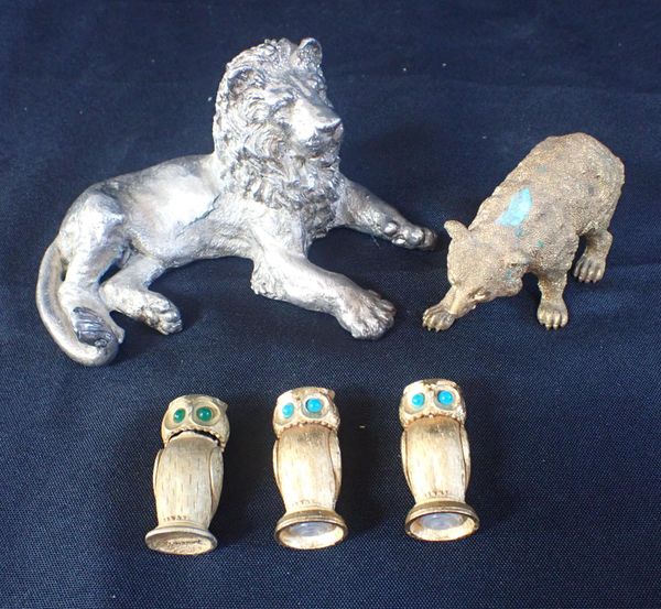 AN UNMARKED WHITE METAL COATED LION