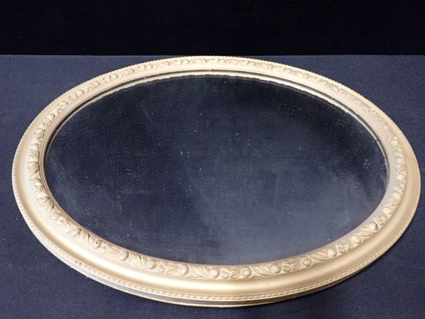 A MOULDED AND GILT PAINTED MIRROR