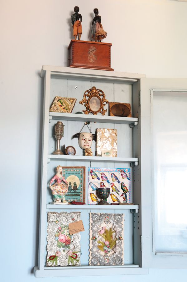 A MODERN PALE BLUE WALL CABINET OF CURIOSITIES