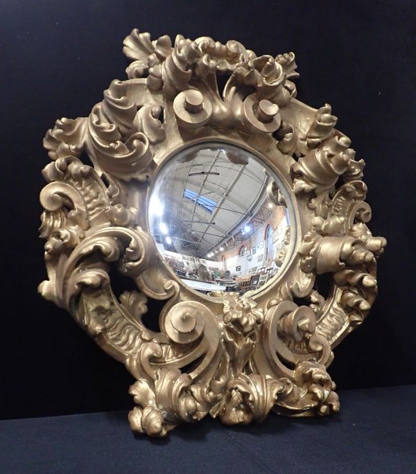 A PROFUSELY CARVED BAROQUE STYLE GILTWOOD MIRROR