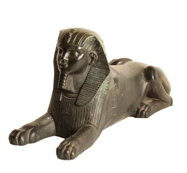 A CONTINENTAL BRONZE MODEL OF A RECUMBENT SPHINX,