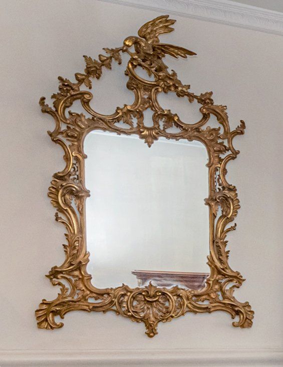 A GEORGE III STYLE GILTWOOD MIRROR IN THE MANNER OF THOMAS CHIPPENDALE