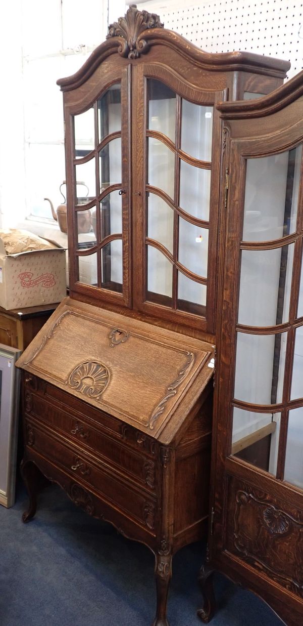 A FRENCH PROVINCIAL CARVED OAK BUREAU BOOKCASE