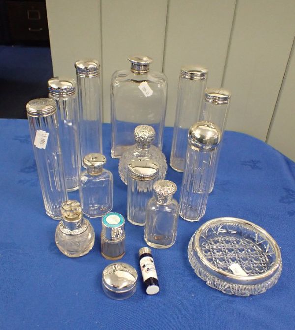 A COLLECTION OF SILVER TOPPED GLASS BOTTLES