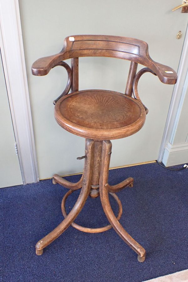 A FISCHEL BENTWOOD SWIVEL ARMCHAIR