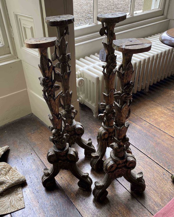 TWO PAIRS OF CONTINENTAL CARVED AND GILTWOOD ALTAR STICKS,