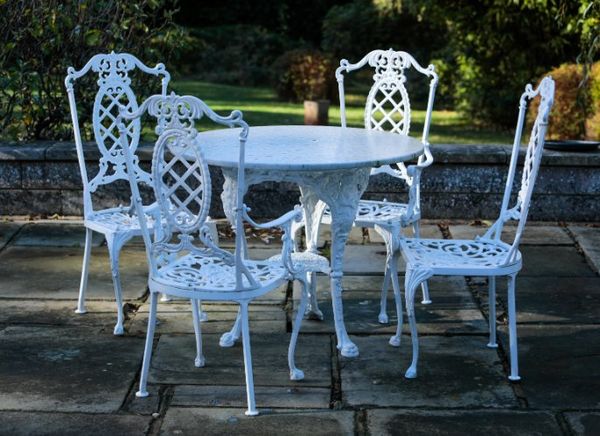 A SET OF FOUR COALBROOKDALE STYLE PAINTED CAST-IRON GARDEN CHAIRS