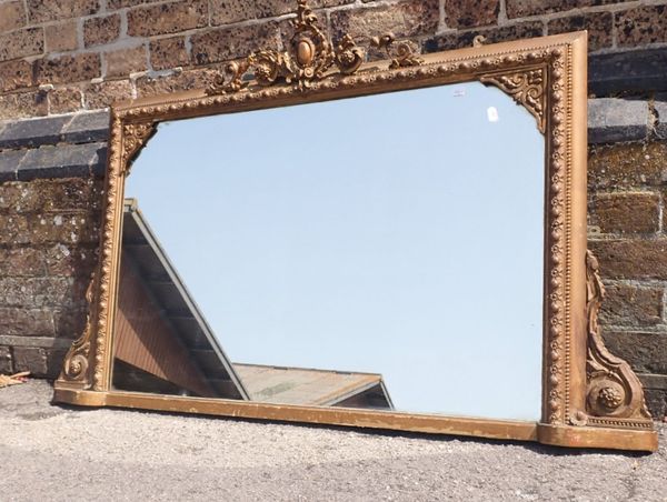 A GILT VICTORIAN FRAMED OVERMANTEL MIRROR