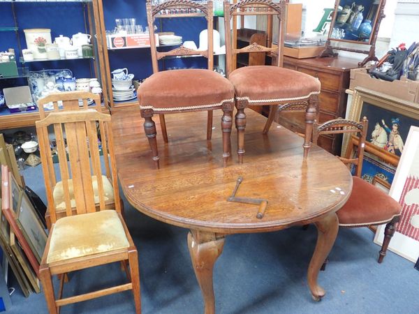 AN EDWARDIAN OAK  WIND-OUT DINING TABLE