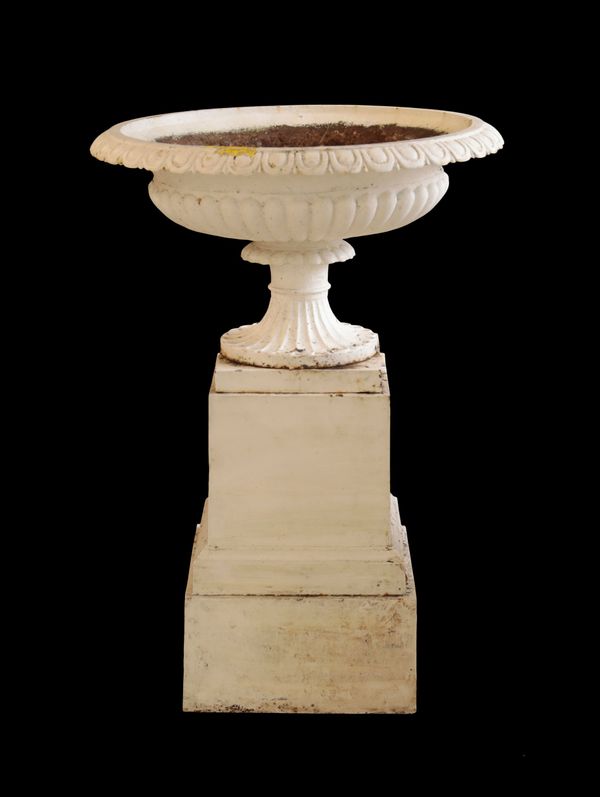 A WHITE PAINTED CAST IRON URN ON PLINTH,